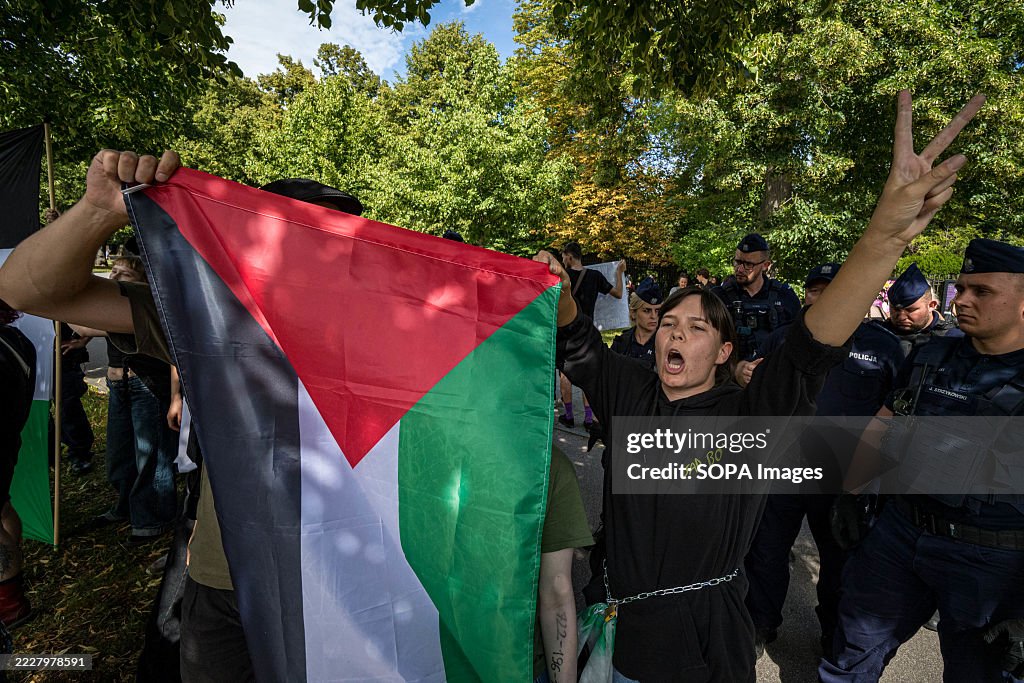 Protestet A protester makes gestures while holding the Palestinian flag during ...
