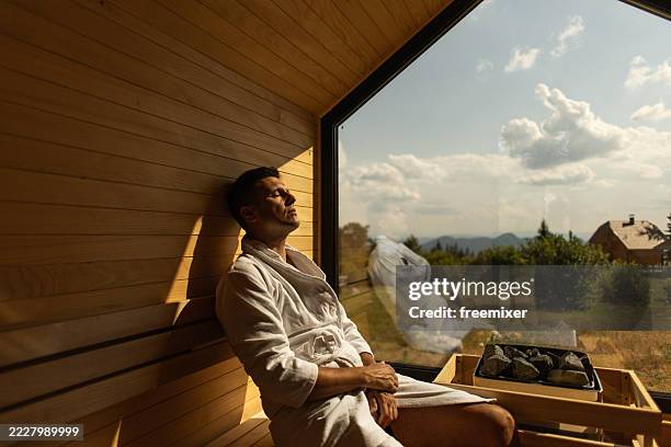 man relaxing in sauna - sauna stockfoto's en -beelden