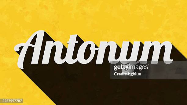 antonym - text with long shadow on textured yellow background - reverse stock illustrations