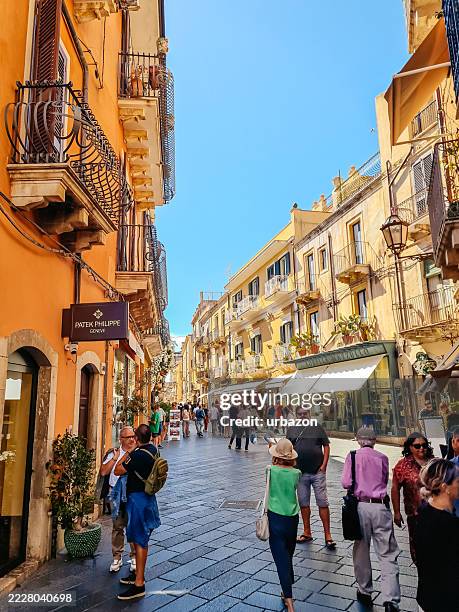 city street during the day in taormina in italy - taormina stock pictures, royalty-free photos & images