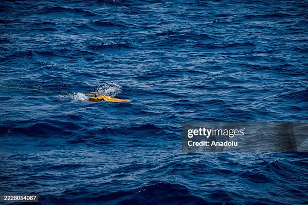 Remote Operated Vehicle is seen being raised to the surface before being lowered to the bottom for the next dive during the Search and Rescue mission...