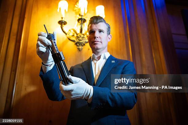 Darth Vader's hero duelling lightsaber on display at The Dorcester in London ahead of an auction in Los Angeles in September 2025. Picture date:...