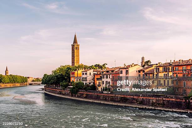 colourful vibrant houses along adige river riverbank in verona, italy - verona italy stock pictures, royalty-free photos & images