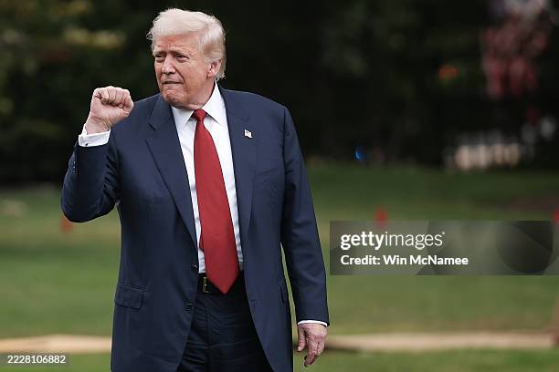 President Donald Trump pumps his fist while gesturing to a group of supporters as he departs the White House on August 01, 2025 in Washington, DC....