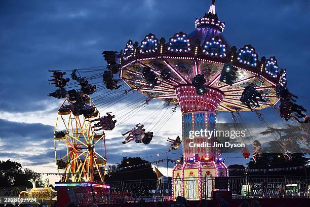Festival goers enjoy a fairground ride during Wilderness Festival at Cornbury Park on August 01, 2025 in Charlbury, Oxfordshire.