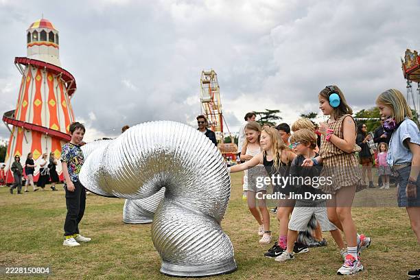 Performers entertain children during Wilderness Festival at Cornbury Park on August 01, 2025 in Charlbury, Oxfordshire.
