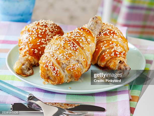 chicken legs wrapped in puff pastry. chicken baked in pastry. chicken leg in puff pastry - puff pastry stock pictures, royalty-free photos & images