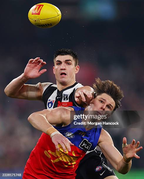 Brayden Maynard of the Magpies and Eric Hipwood of the Lions compete for the ball during the round 21 AFL match between Collingwood Magpies and...