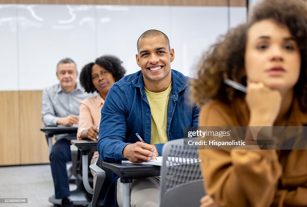 Happy university student paying attention in class