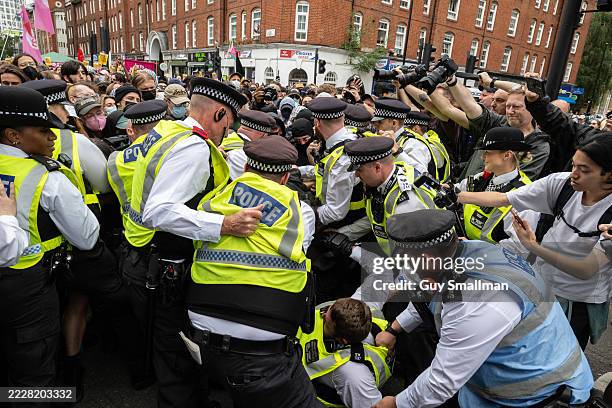 Police snatch squads scuffle with anti fascist protesters on August 2, 2025 in London, England. Far-right protests focusing on hotels housing asylum...