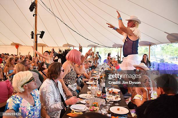 Festival goers enjoy the atmosphere as chef Angela Hartnett hosts a long table banquet during Wilderness Festival at Cornbury Park on August 02, 2025...