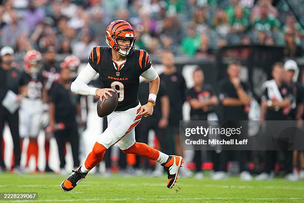 Joe Burrow of the Cincinnati Bengals scrambles against the Philadelphia Eagles in the first half of the NFL Preseason 2025 game at Lincoln Financial...