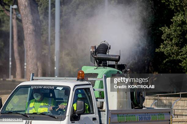 Pickup truck performs a disinfection in a public park in the city center against mosquitos carrying the West Nile virus. Following the occurrence of...