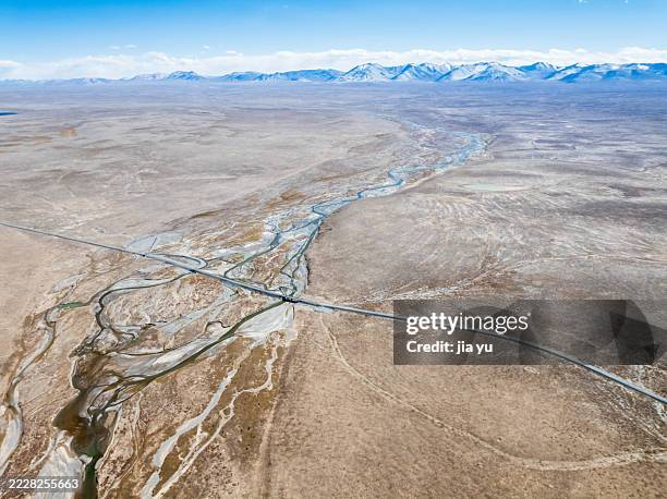 aerial view of winding river through vast arid landscape - wassermangel stock-fotos und bilder