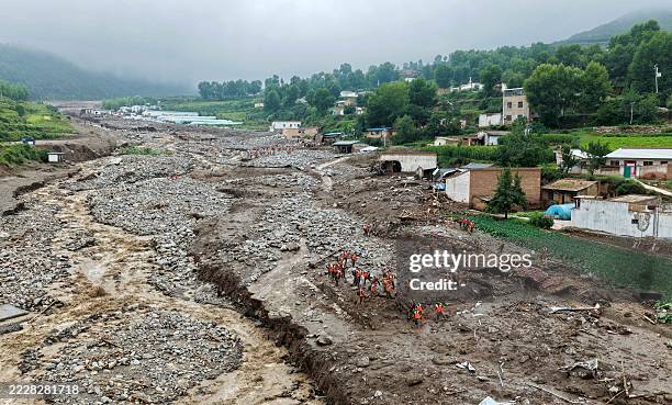 Rescue workers search for survivors after a flash flood in Yuzhong county, in China's northwest Gansu province on August 8, 2025. Ten people are dead...