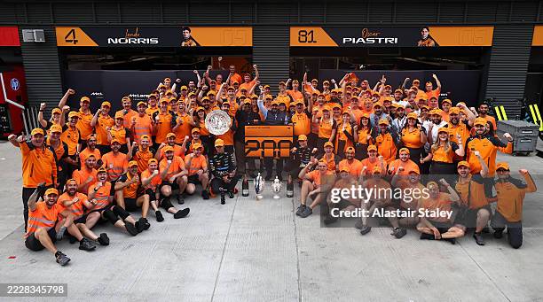 Race winner Lando Norris of Great Britain and McLaren Second placed Oscar Piastri of Australia and McLaren and the McLaren team celebrate during the...