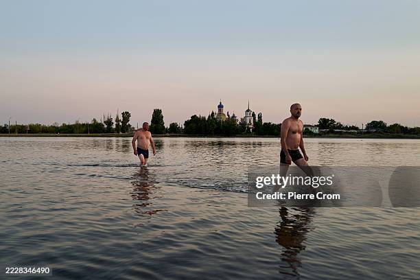 Bathers emerge from Lake Veysovo, a saltwater lake renowned for its therapeutic properties on August 8, 2025 in Sloviansk, Ukraine. Sloviansk is the...