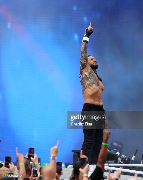 Tag Rome Roman Reigns makes an entrance before the tag team match during the ...