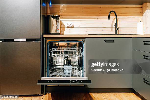 open dishwasher in modern kitchen with wooden countertop - unloading stock pictures, royalty-free photos & images