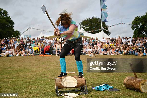 British Timbersports champion Rachel Ferrington performs at the Playing Fields during the Wilderness Country Show at Wilderness Festival at Cornbury...