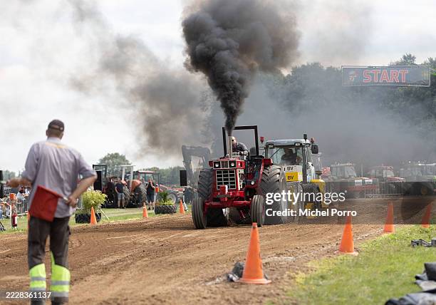 Tractor operator pulls a sled loaded with a heavy weight in the tractor pulling games, locally called 'Trekker Trek', on August 03, 2025 in Laren,...