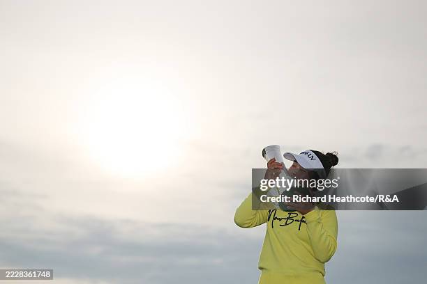 Miyu Yamashita of Japan kisses the AIG Women's Open trophy following victory in the final round of the AIG Women's Open 2025 at Royal Porthcawl Golf...