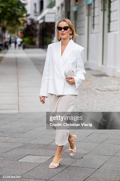 Tina Haase wears Mango White padded shoulder blazer, transparent skirt, White strappy heels, pearl clutch bag, Joseph sunglasses on August 03, 2025...