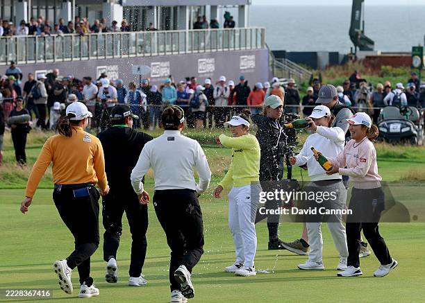 Miyu Yamashita of Japan is sprayed with champagne by fellow Japanese players on the 18th after she had holed the winning putt during the final round...