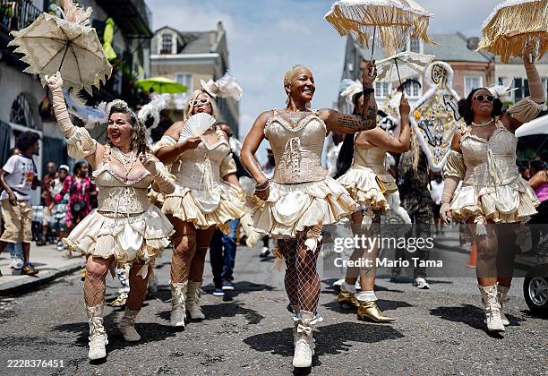 Members of the Mahogany Blue Baby Dolls march in the 25th Anniversary Satchmo Salute second line parade, honoring New Orleans jazz legend Louis...