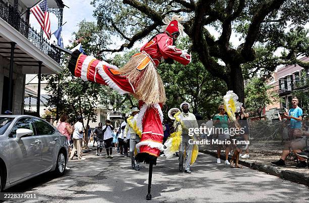 Stilt walker dances in the 25th Anniversary Satchmo Salute second line parade, honoring New Orleans jazz legend Louis Armstrong, on August 3, 2025 in...