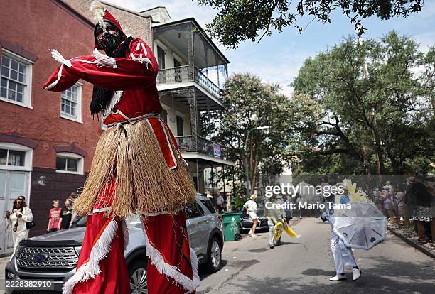 Stilt walker marches in the 25th Anniversary Satchmo Salute second line parade, honoring New Orleans jazz legend Louis Armstrong, on August 3, 2025...