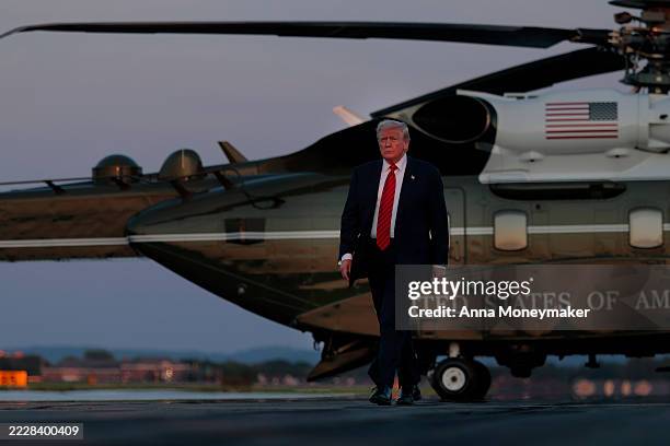President Donald Trump walks towards reporters from Marine One at at the Lehigh Valley International Airport on August 03, 2025 in Allentown,...