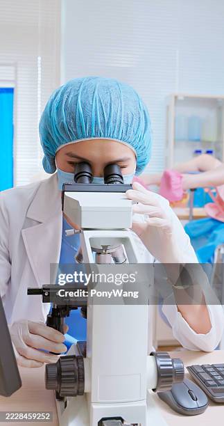 asian doctor microscope cervical smear sample clinic - colposcopy stock pictures, royalty-free photos & images