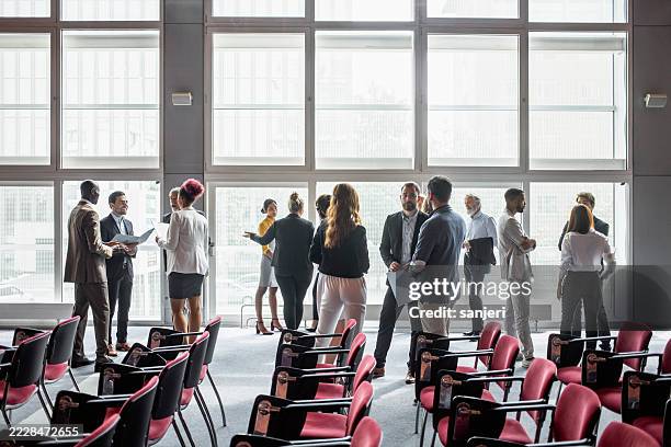 diverse group of professionals networking at business conference - summit meeting stock pictures, royalty-free photos & images