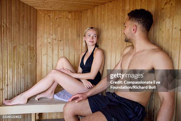 couple relaxing in beach sauna - badkläder bildbanksfoton och bilder