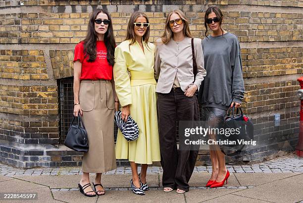 Annabel Rosendahl wears red shirt, beige skirt, black bag & Nina Sandbech wears yellow dress, zebra print bag & Tine Andrea wears grey jacket, brown...