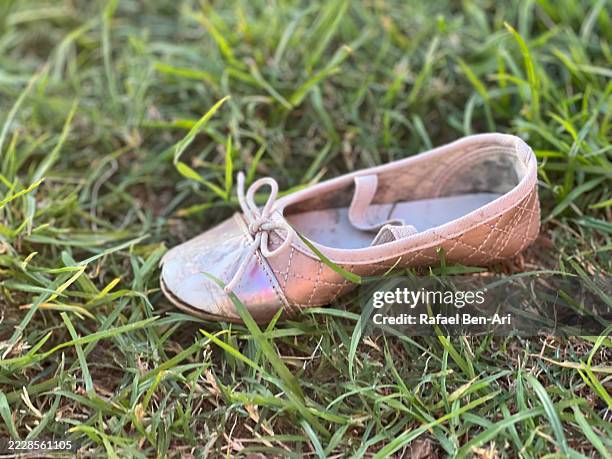 girl shoe on green grass - missing persons stock pictures, royalty-free photos & images