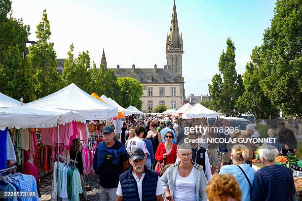 Crowds of tourists and Breton residents line the aisles of the weekly food and non-food market in Saint Pol de Leon, Brittany, France, on August 5,...