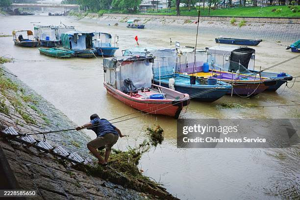 Local residents clean up garbage in Lam Tsuen River in the rain on August 5, 2025 in Hong Kong, China. The Hong Kong Observatory issued a black...