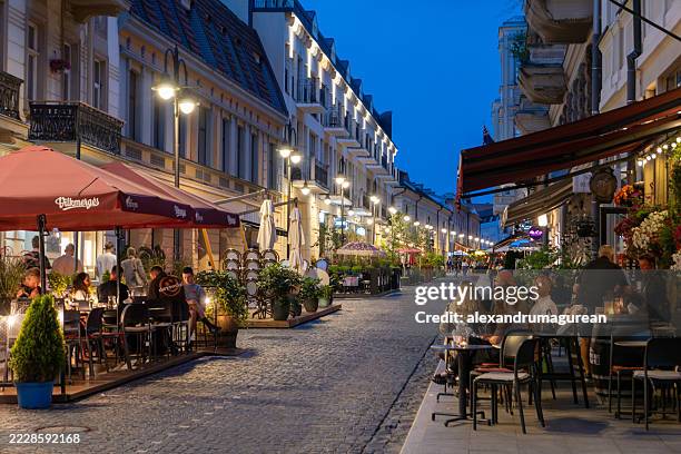 evening dining scene on a charming vilnius street - vilnius stock pictures, royalty-free photos & images