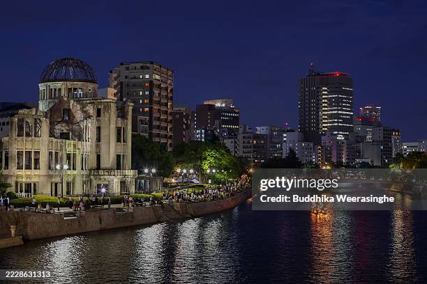 People are seen visiting the Atomic Bomb Dome at night ahead of the 80th anniversary of the atomic bomb dropped on Hiroshima at the Hiroshima Peace...