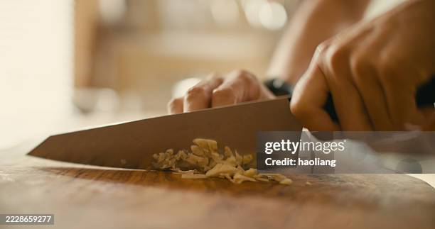 chopping garlic cloves - chopping garlic stock pictures, royalty-free photos & images