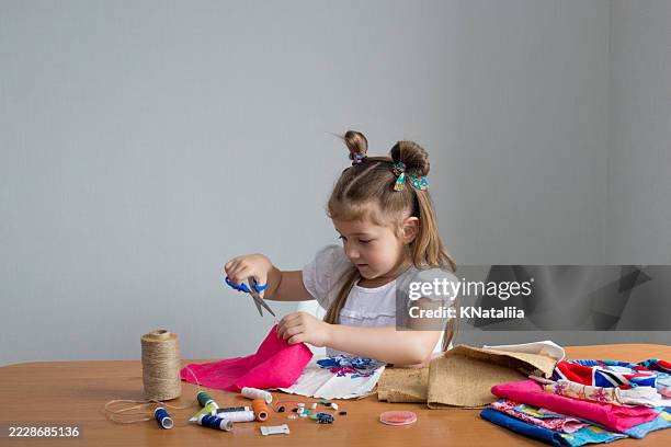 girl crafting patchwork with fabric and thread - homemade stock pictures, royalty-free photos & images