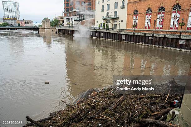 Debris piles up on a bridge piling on the Milwaukee River after heavy rain in the area on August 10, 2025 in Milwaukee, Wisconsin. Heavy downpours...