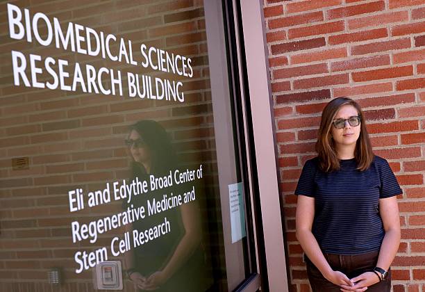Sydney Campbell, a UCLA cancer researcher whose grant funding has been cut, stands outside the front door to the Biomedical Sciences Research...