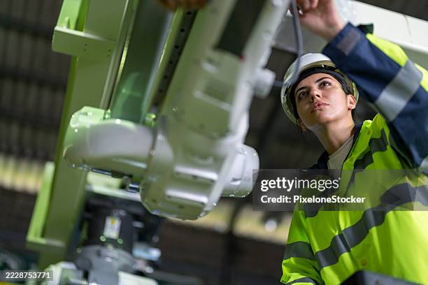 female engineer inspecting the robotic collaborative conveyor systems during installation in factory. - installing software stock pictures, royalty-free photos & images
