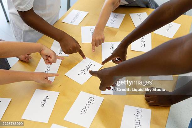 students choosing justice among other values in a classroom - learning spanish stock pictures, royalty-free photos & images