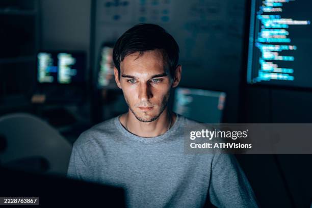 focused software developer working at night - python code stock pictures, royalty-free photos & images