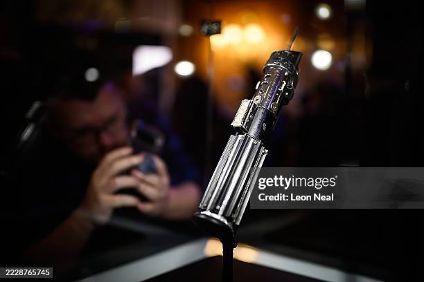 The screen-matched lightsaber prop, used by the character "Darth Vader" in the Star Wars films "The Empire Strikes Back and "Return Of The Jedi", is...
