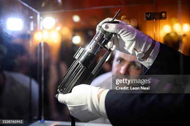 The screen-matched lightsaber prop, used by the character "Darth Vader" in the Star Wars films "The Empire Strikes Back and "Return Of The Jedi", is...